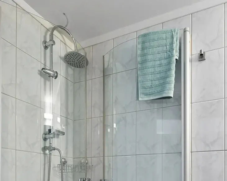 What is the purpose of a slide bar on a shower head?